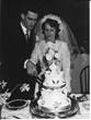 Betty and Paul cutting wedding cake